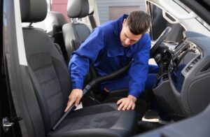 Man cleaning car seat.