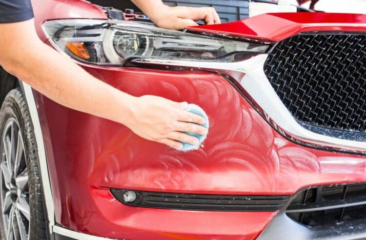 Applying car wax.